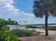 Scenic beach view with palm trees and calm ocean at 4513 Lexington Cir, Bradenton, FL 34210