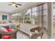 Sunroom with wicker furniture and large windows overlooking the garden at 4803 Park Acres Dr, Bradenton, FL 34207