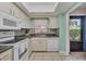 Clean and efficient kitchen with white appliances and light cabinets at 4803 Park Acres Dr, Bradenton, FL 34207