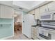 Well-equipped kitchen with white appliances and a view of the dining area at 4803 Park Acres Dr, Bradenton, FL 34207