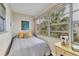 Bright sunroom with a comfortable bed and garden views at 4803 Park Acres Dr, Bradenton, FL 34207