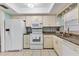 Bright kitchen features white appliances and ample counter space at 4803 Park Acres Dr, Bradenton, FL 34207