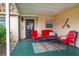 Covered patio with red chairs and rug at 4803 Park Acres Dr, Bradenton, FL 34207