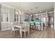 Bright dining room with white table and chairs near kitchen at 505 N Tamiami Trail # 202, Venice, FL 34285