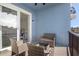 Relaxing balcony with wicker furniture and view of the bedroom at 505 N Tamiami Trail # 202, Venice, FL 34285