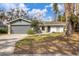 Ranch-style home with gray exterior, white trim, and a two-car garage at 5470 80Th Avenue E Cir, Palmetto, FL 34221