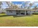 House exterior with covered patio and grassy yard at 5470 80Th Avenue E Cir, Palmetto, FL 34221