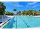Enjoy this bright and clean community pool with ample seating and lush landscaping at 5644 Ashton Lake Dr # 5644, Sarasota, FL 34231