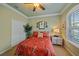 Guest bedroom with tropical bedding and plantation shutters at 6023 Wingspan Way, Bradenton, FL 34203