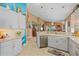 Modern kitchen with light cabinets, stainless steel appliances, and a large island at 6023 Wingspan Way, Bradenton, FL 34203