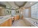 Bathroom with double vanity and large soaking tub at 6023 Wingspan Way, Bradenton, FL 34203