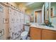 Clean bathroom with shower/tub combo and wood cabinets at 6023 Wingspan Way, Bradenton, FL 34203