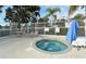 Community hot tub with lounge chairs and surrounding fence at 6023 Wingspan Way, Bradenton, FL 34203