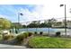Community tennis court with seating area and surrounding landscaping at 6023 Wingspan Way, Bradenton, FL 34203