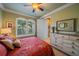 Guest bedroom with a dresser and a queen-size bed at 6023 Wingspan Way, Bradenton, FL 34203
