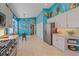 Modern kitchen with light cabinets and stainless steel appliances, and a built in microwave at 6023 Wingspan Way, Bradenton, FL 34203