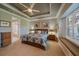 Main bedroom with a king-size bed and window seat at 6023 Wingspan Way, Bradenton, FL 34203