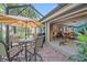Screened patio with table, chairs, and view of backyard at 6023 Wingspan Way, Bradenton, FL 34203