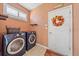 Bright laundry room with washer, dryer, and ample storage at 6023 Wingspan Way, Bradenton, FL 34203