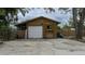 Detached garage with large white door and driveway at 6211 30Th E Ave, Palmetto, FL 34221