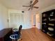 Bedroom with wood floors, ceiling fan and bookcase at 6447 Egret Ln # 413, Bradenton, FL 34210