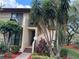 Exterior view of condo building with lush landscaping and walkway at 6447 Egret Ln # 413, Bradenton, FL 34210