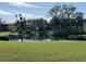 Serene pond view with lush landscaping and condo buildings in the background at 6447 Egret Ln # 413, Bradenton, FL 34210