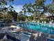 Community pool with lounge chairs and patio furniture at 6447 Egret Ln # 413, Bradenton, FL 34210
