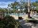 Inviting community pool with surrounding landscaping at 6447 Egret Ln # 413, Bradenton, FL 34210