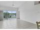 Spacious living area with tile flooring and sliding glass doors to balcony at 7216 Cedar Hollow Cir # 9-202, Bradenton, FL 34203