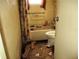 Bathroom showing damage with a toilet and tub-shower combo at 840 Harvard St, Englewood, FL 34223