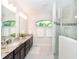 Elegant bathroom with double vanity, granite countertops, and a large walk-in shower at 85 Spaniards Rd, Placida, FL 33946