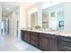 Double vanity bathroom with granite countertops and dark brown cabinets at 85 Spaniards Rd, Placida, FL 33946