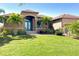 Front view of single-story home with teal door and landscaping at 85 Spaniards Rd, Placida, FL 33946
