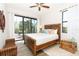 Bedroom with sliding glass doors to the patio and tropical decor at 85 Spaniards Rd, Placida, FL 33946