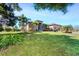 House exterior with landscaping, palm trees, and a large front yard at 85 Spaniards Rd, Placida, FL 33946