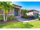 Single-Gathering home with palm trees, walkway, and attached garage at 85 Spaniards Rd, Placida, FL 33946