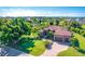 Aerial view of single-story home with tile roof, large yard, and paved driveway at 85 Spaniards Rd, Placida, FL 33946
