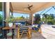 Spacious covered patio with seating area and grill, overlooking the pool at 85 Spaniards Rd, Placida, FL 33946