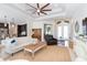 Spacious living room with light furniture, ceiling fan, and large windows at 85 Spaniards Rd, Placida, FL 33946