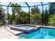 Screened-in spa with water feature and lush landscaping at 85 Spaniards Rd, Placida, FL 33946