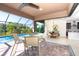 Relaxing poolside patio with seating area and view of the pool at 85 Spaniards Rd, Placida, FL 33946