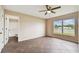 Bedroom with large window, ceiling fan, and en-suite bathroom at 11814 Colyar Ln, Parrish, FL 34219