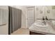 Clean bathroom with double sinks, shower, and gray curtain at 12703 Night View Dr, Sarasota, FL 34238