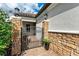 Wrought iron gate with stone pillars leading to the front entrance of a home at 13902 Messina Loop, Bradenton, FL 34211