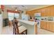 Open kitchen with light wood cabinets, breakfast bar, and ample counter space at 1422 Blue Horizon Cir, Bradenton, FL 34208