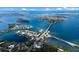 Aerial view showcases waterfront home, bridge, and surrounding neighborhood at 1521 Siesta Dr, Sarasota, FL 34239