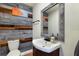 Small bathroom with wood-paneled walls and a pedestal sink at 1521 Siesta Dr, Sarasota, FL 34239