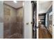 Shower with tile surround and access to bedroom closet at 1521 Siesta Dr, Sarasota, FL 34239