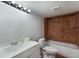 Clean basement bathroom with tub, toilet, and vanity at 1521 Siesta Dr, Sarasota, FL 34239